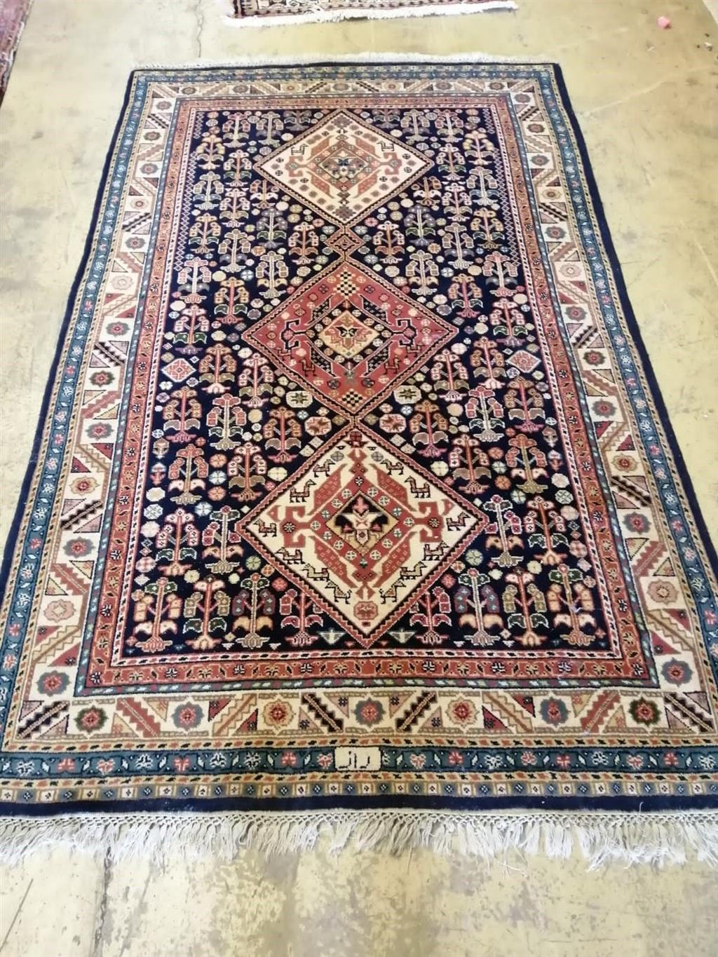 A Caucasian blue ground rug, 220 x 130cm